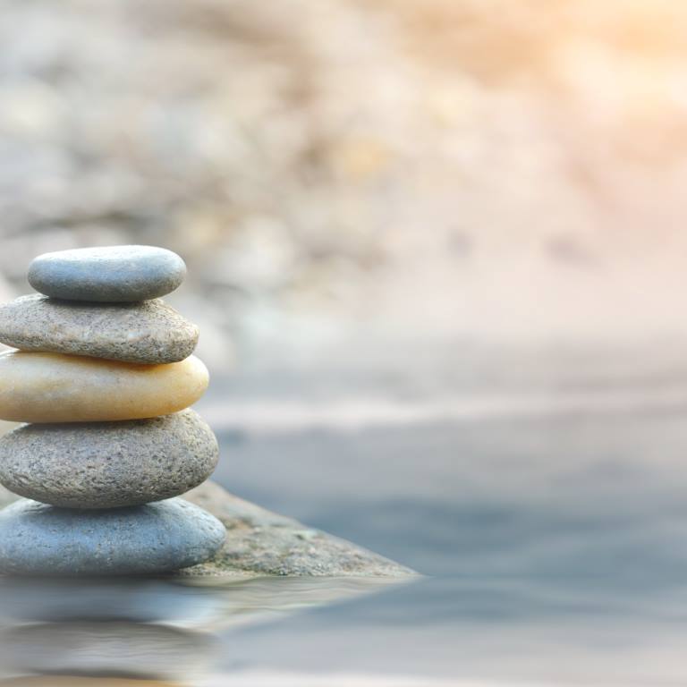 Balance stone with spa on river coast